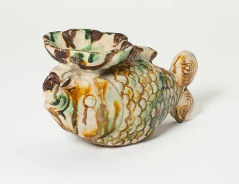 Chinese oil lamp shaped like a fish, glazed in three colours, 8th century